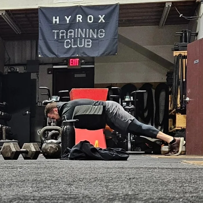 Coach carrying a kettlebell during a First-In Fitness tactical training session