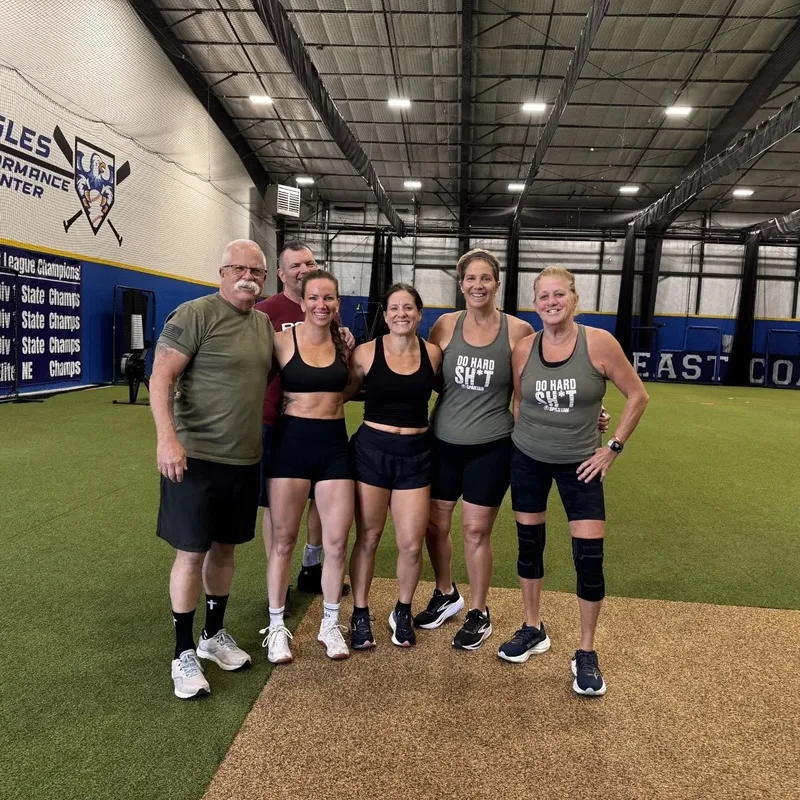 Group of Cynergy athletes posing together after a workout